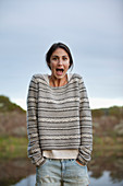Portrait of surprised woman at lakeside