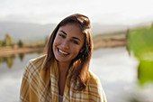 Portrait of smiling woman at lakeside
