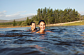 Portrait of smiling couple swimming