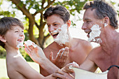 Men applying shaving cream