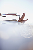 Woman's feet resting on convertible