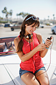 Woman listening to mp3 player on car