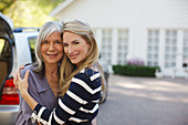 Mother and daughter hugging outdoors