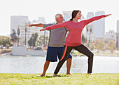 Older couple practicing yoga outdoors