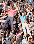 Portrait of man and woman crowd surfing