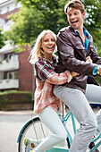 Couple riding bicycle together