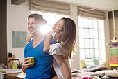 Smiling couple hugging in kitchen
