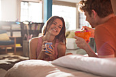 Couple having breakfast in bed together