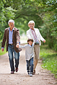 Couple walking with grandson