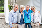 Friends standing together outside house