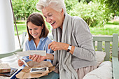 Woman and granddaughter looking at photos