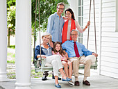 Family smiling together on porch