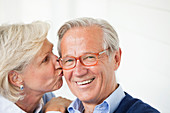 Smiling woman kissing husband