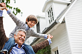 Man carrying grandson on shoulders