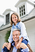 Man carrying granddaughter