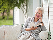 Woman reading in porch swing