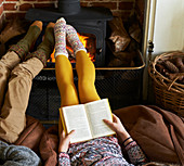 Children relaxing by fire