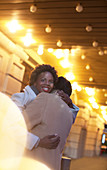 Couple hugging on city street