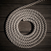 Rope coiled into circle on boardwalk