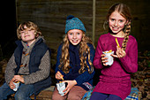 Smiling children eating french fries