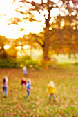 Blurred view of children in field
