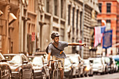 Man riding bicycle on city street