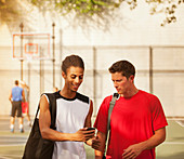 Men talking on basketball court