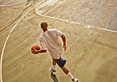 Man playing basketball on court