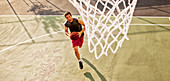 Man playing basketball on court