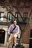 Man riding bicycle on city street