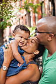 Family hugging on city street