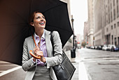 Businesswoman holding umbrella