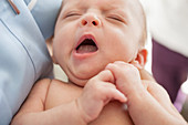 Close up of newborn baby yawning