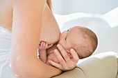 Mother breastfeeding newborn baby