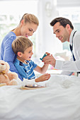 Doctor giving son asthma inhaler