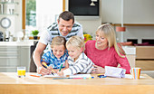 Family coloring together at table