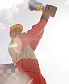 Racer holding trophy at award ceremony