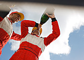 Racer drinking champagne on track
