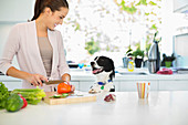 Woman chopping vegetables in kitchen