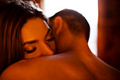 Couple kissing in bedroom