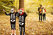 Children in skeleton costumes in park