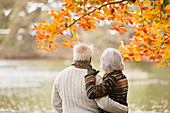Older couple standing in park