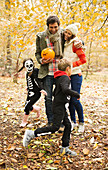 Couple with children in skeleton costumes