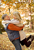 Older couple hugging in park