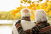 Older couple hugging in park