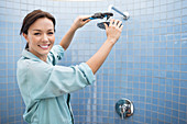 Female plumber working on shower head