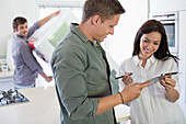 Woman signing for delivery in kitchen