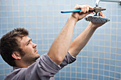 Plumber working on shower head