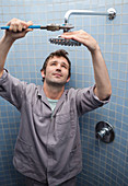 Plumber working on shower head