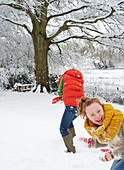 Mother and daughter playing in snow